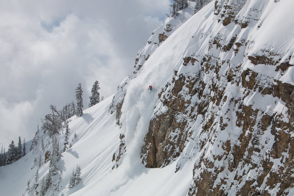 Skier dropping in at Jackson Hole Resort on skis rented from the Mudroom in Teton Village, Wyoming.